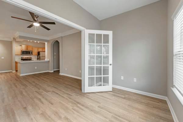 Empty living room with a ceiling fan and wood-style flooring at The Legends At ChampionsGate in ChampionsGate, Florida