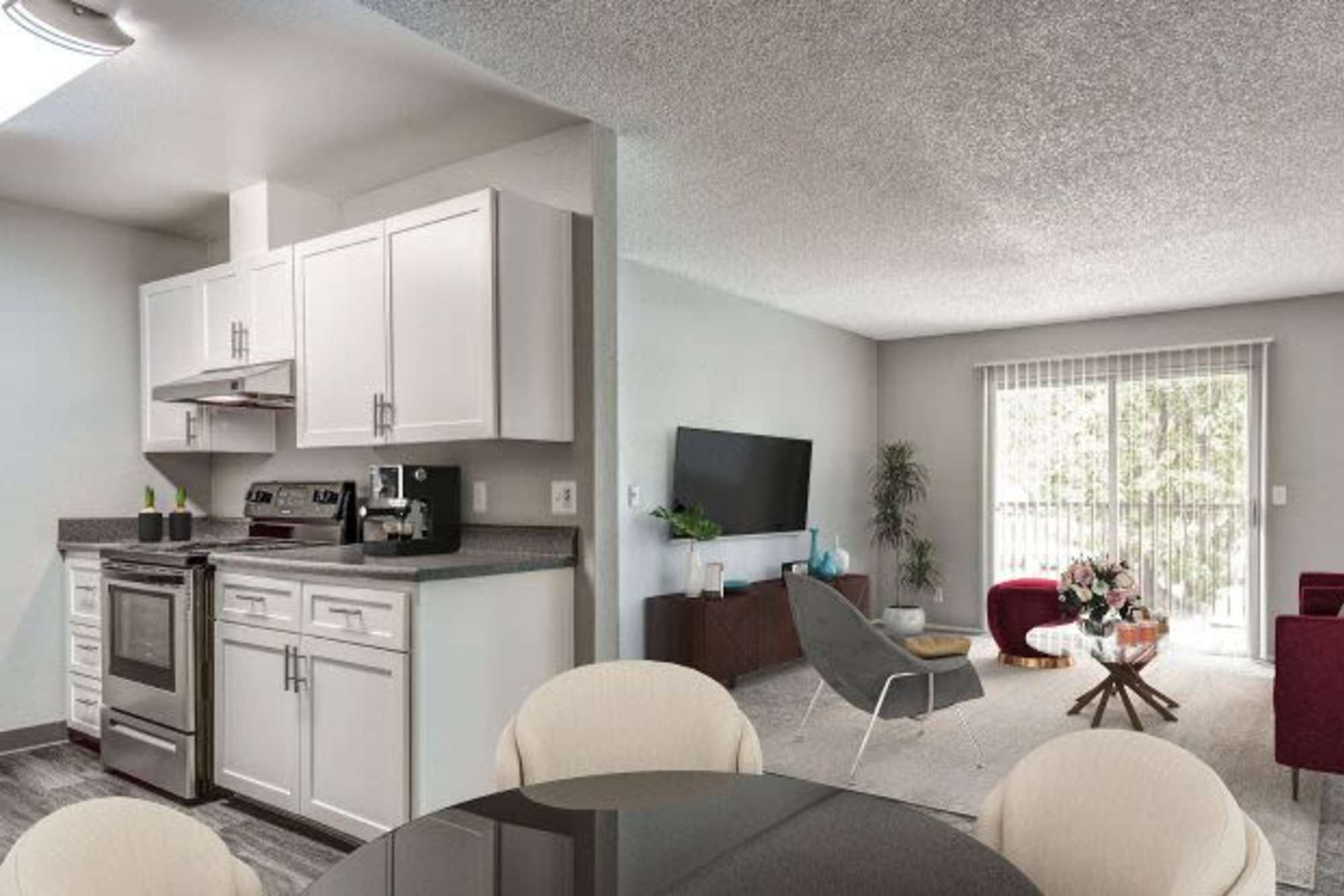 Living room and kitchen at The Woodlands Apartments in Sacramento, California