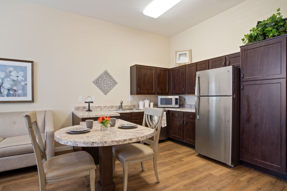 An apartment kitchen, living room and bedroom at Clayton Oaks Living in Richmond, Texas