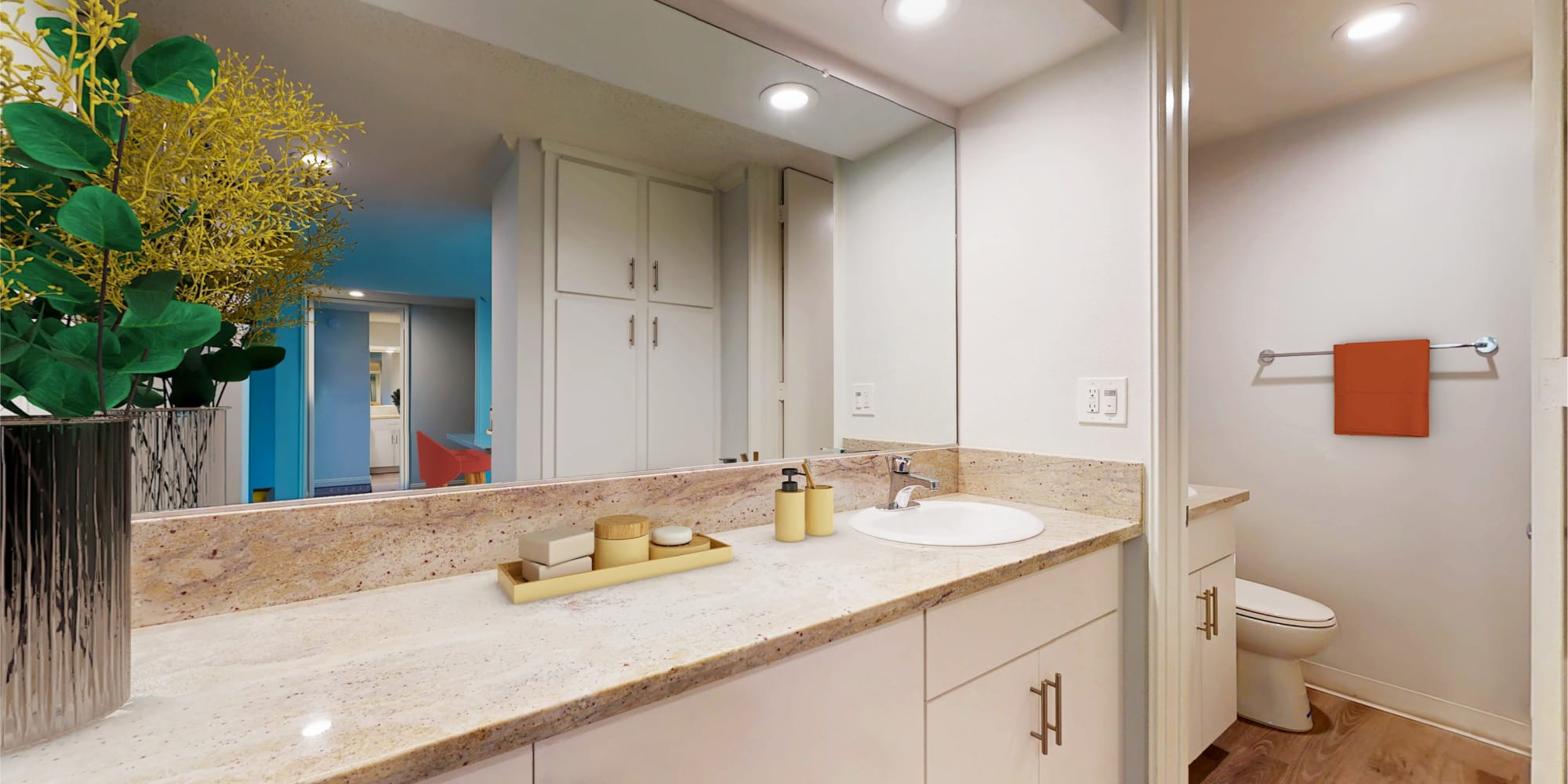 Model home's bathroom with extra storage and a granite countertop at Casa Granada in Los Angeles, California