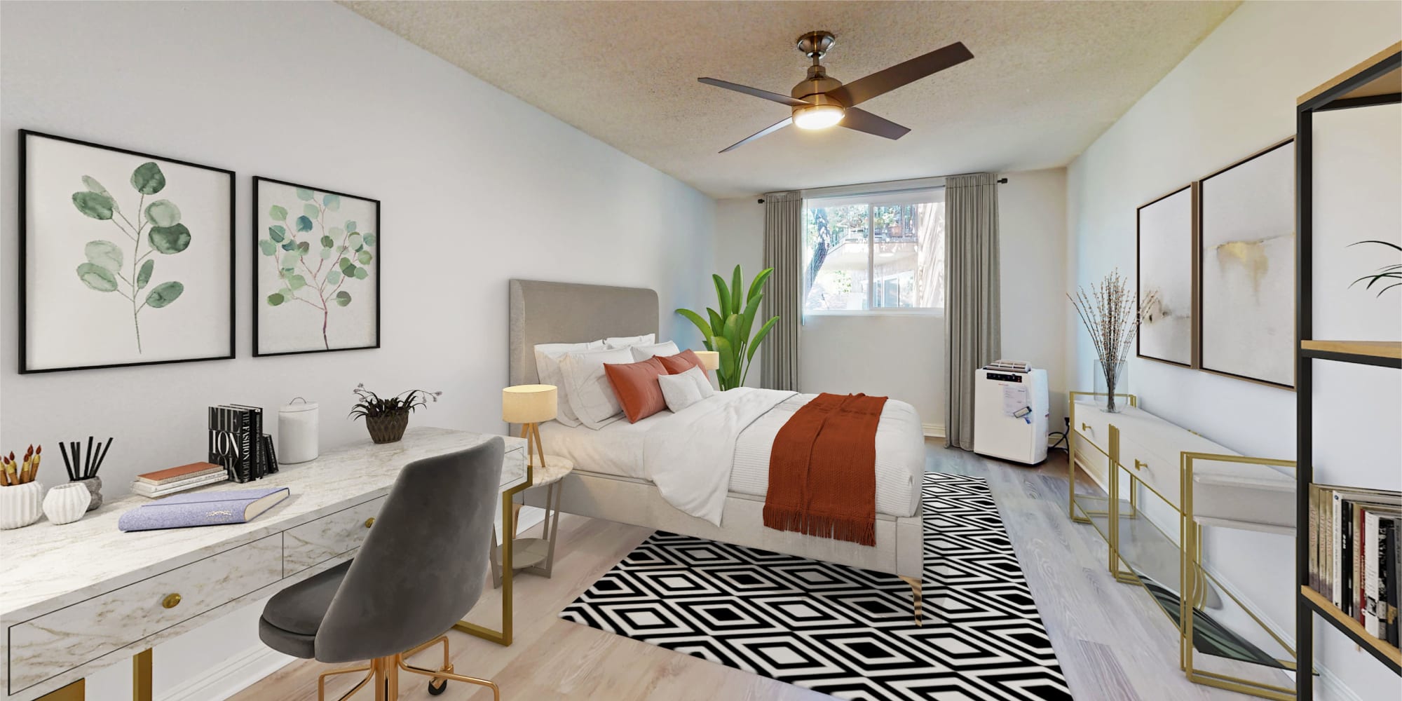 Well-furnished model home's primary bedroom with a ceiling fan at Casa Granada in Los Angeles, California