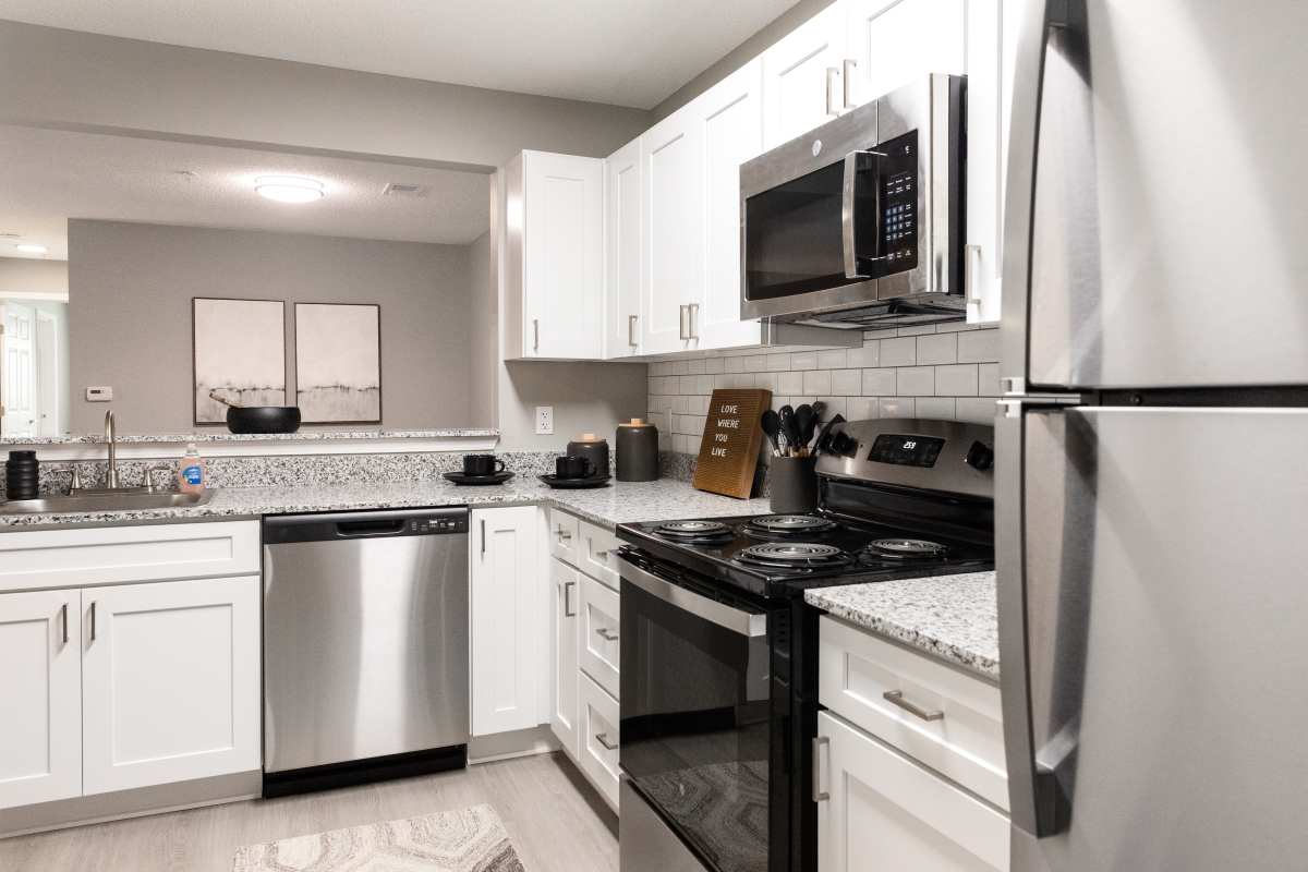 Model kitchen with stainless steel appliances at Atlas at Goodlett Farms in Cordova, Tennessee