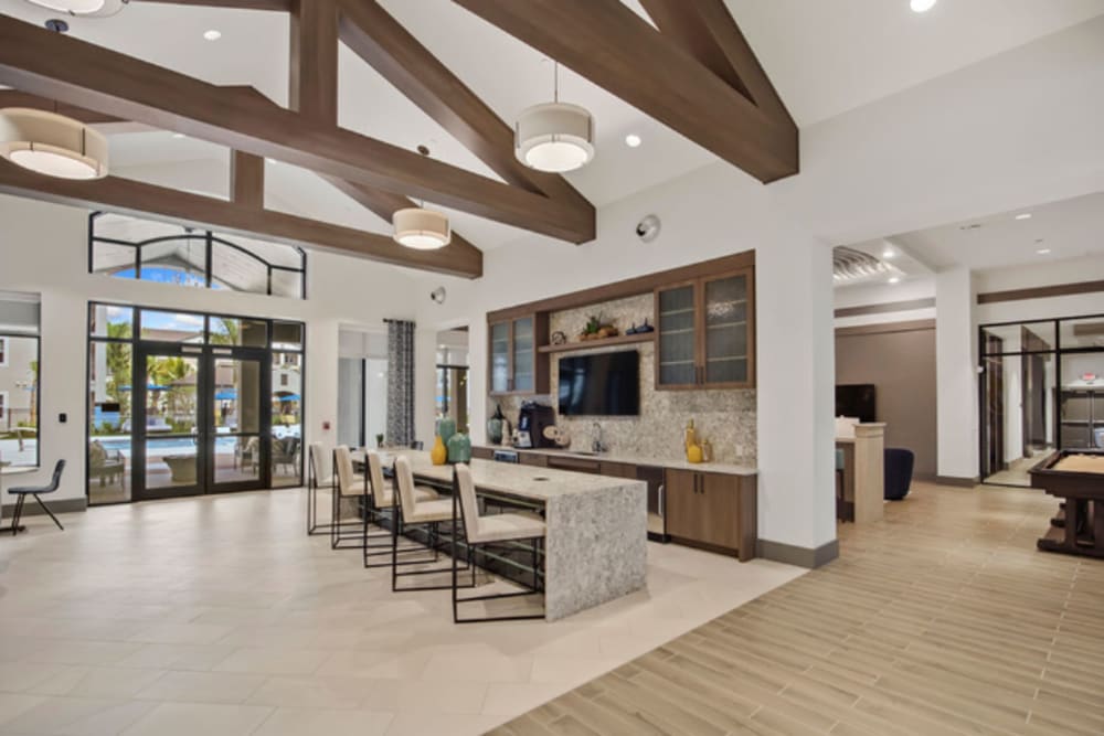Clubhouse interior and resident kitchen at Murano at Three Oaks in Fort Myers, Florida
