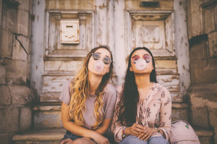 Girls blowing bubbles on a stoep downtown near Waterford Trails in Spring, Texas