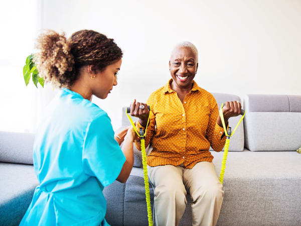 Nurse helping a resident stretch at Careage Home Health in Dupont, Washington. 