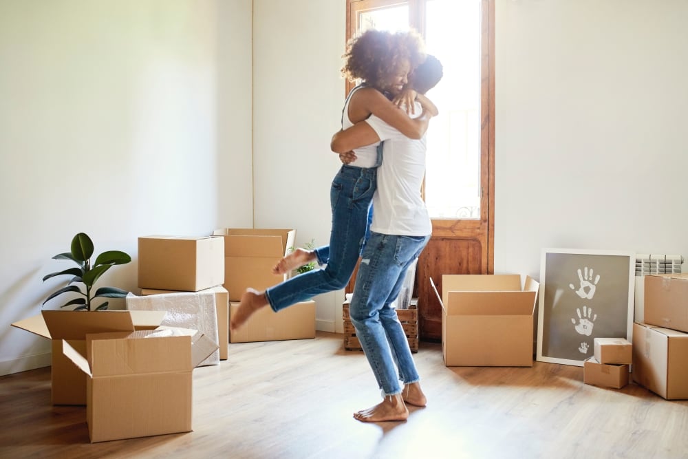A young couple hugging near Hayward Storage LLC in Hayward, California