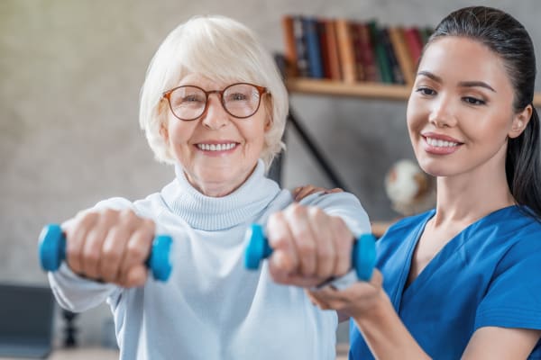 Resident getting help with her exercises at Wellness at Home in Albany, Oregon
