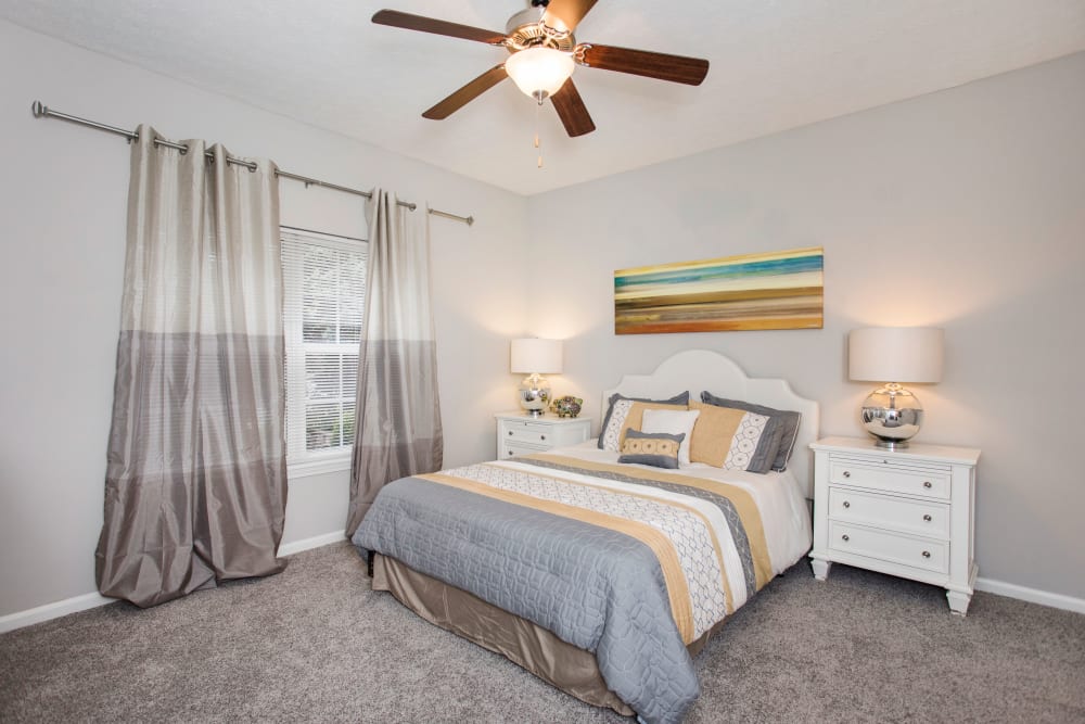 A large bedroom with a ceiling fan at Southgate Landing in Louisville, Kentucky