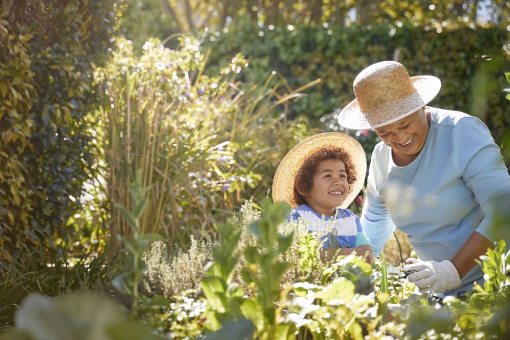 A resident and her grandson gardening near The Joyce in Durham, North Carolina