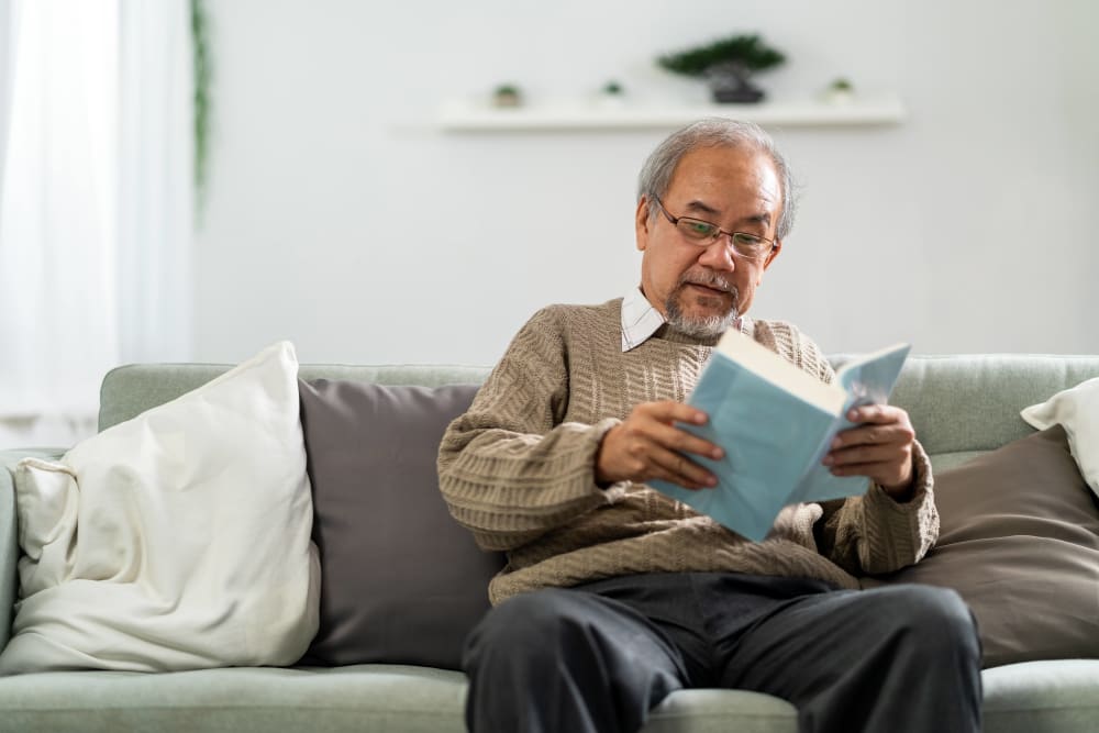 Resident reading in his home at Avion Point Seniors in Charlotte, North Carolina