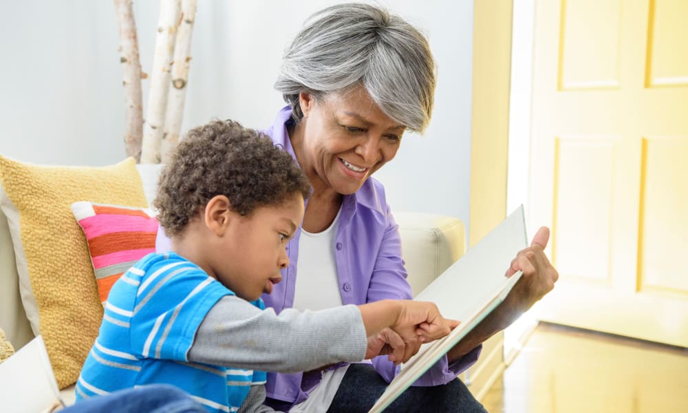 A resident and grandchild reading together at Amaran Senior Living in Albuquerque, New Mexico. 