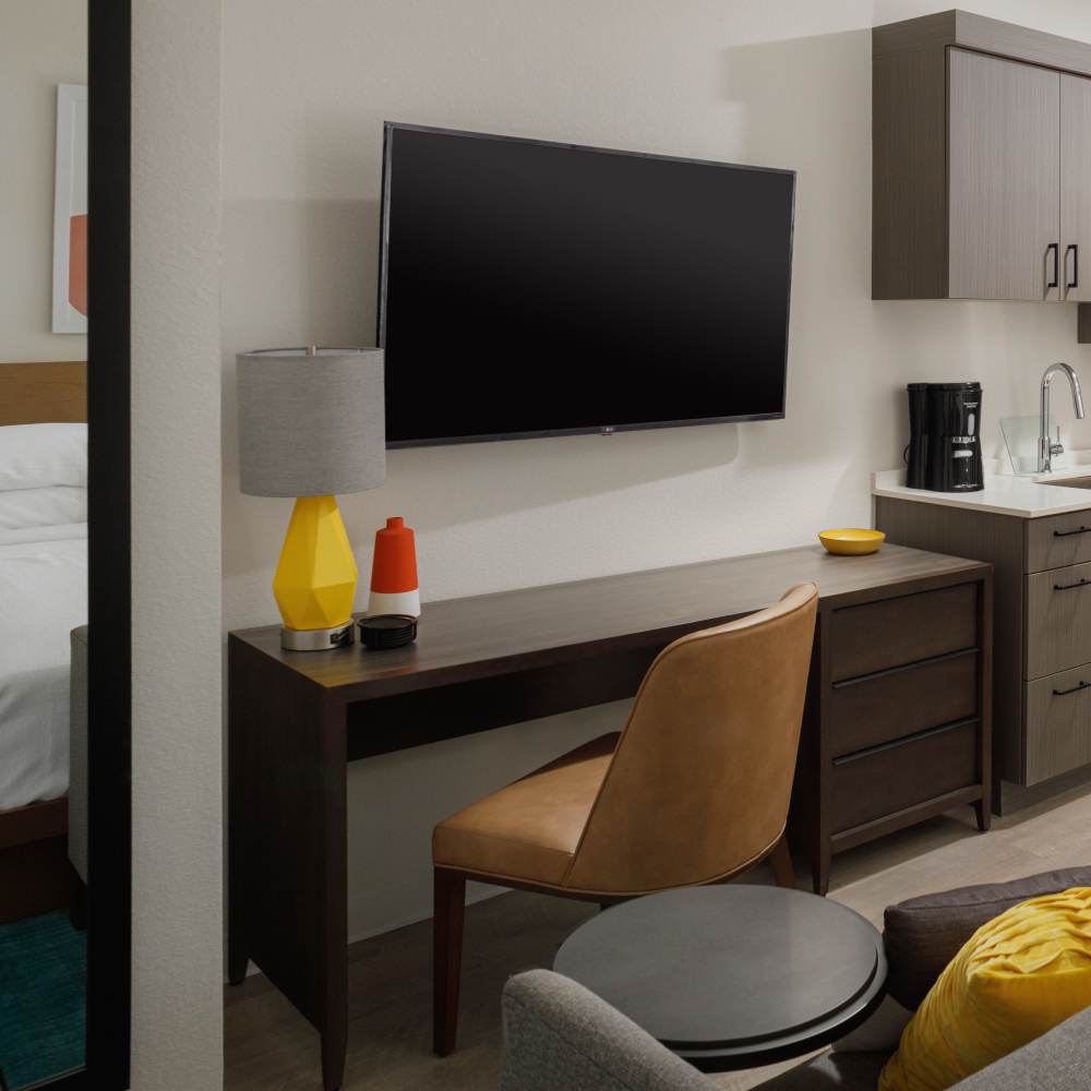 wall-mounted TV, positioned next to a kitchenette at WaterWalk Phoenix - North Happy Valley in Phoenix, Arizona