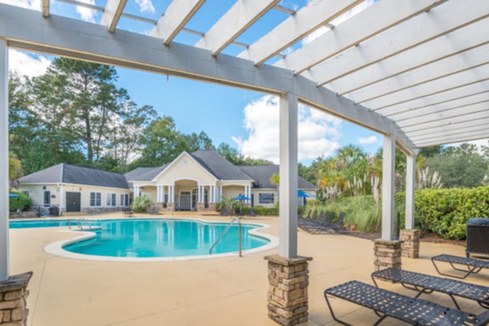 Pergola over lounge chairs near the pool at Walden at Chatham Center in Savannah, Georgia