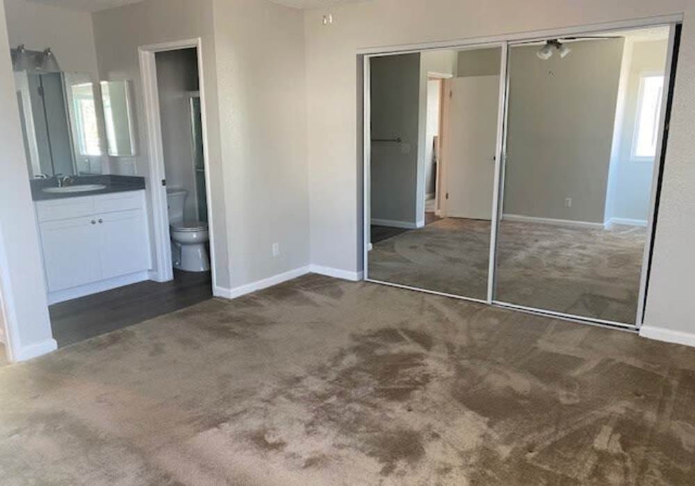 Bedroom with a large mirror at Oak Hill in Escondido, California