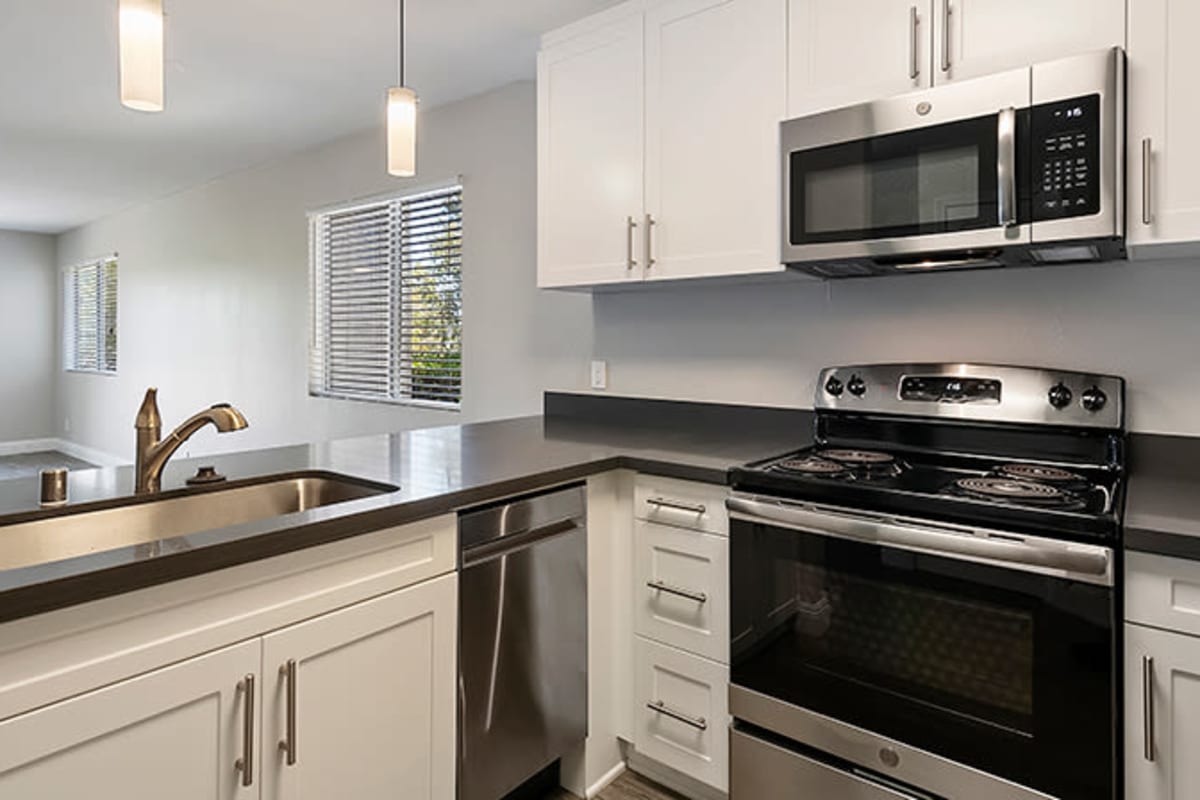 Kitchen with stainless-steel appliances at The Avenue at Carlsbad, Carlsbad, California