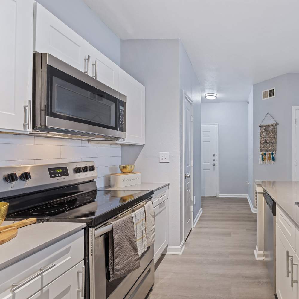 Kitchen with stainless-steel appliances at The Chase Apartments in Dallas, Texas