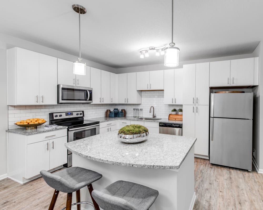 Bright and modern kitchen with a subway-tile backsplash in a model home at Canopy at Citrus Park in Tampa, Florida