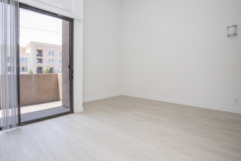 Model living room with door to balcony at Club Marina Apartments in Los Angeles, California