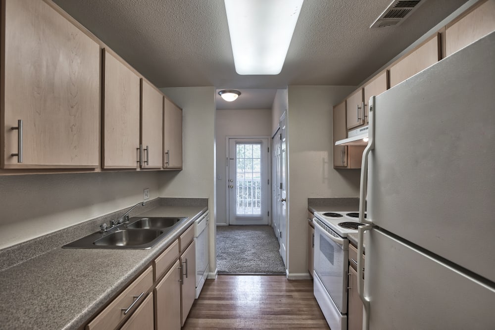 Kitchen with white appliances at Westmeadow Peaks Apartments in Colorado Springs, Colorado