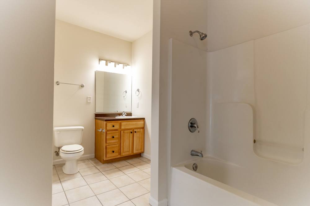 Bright bathroom with vanity lights at Forest Ridge in Bloomington, Indiana, 