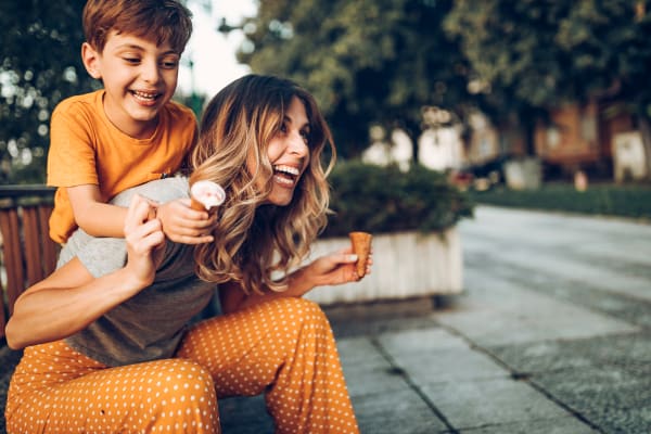 A smiling mother with her son holding ice cream cones near Astoria in Mobile, Alabama