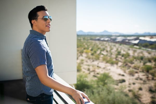 Resident admiring the view from his private balcony at Mira Santi in Chandler, Arizona