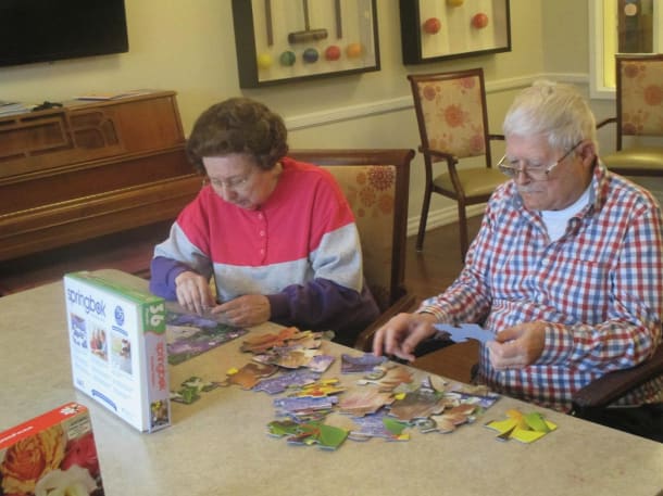 senior citizens doing a puzzle