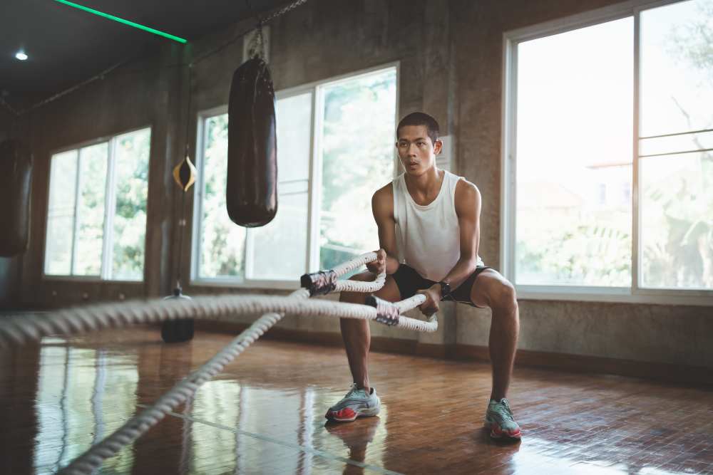 Man exercising with weighted ropes in our fitness center at Workhouse at Union Terminal in Jacksonville, Florida