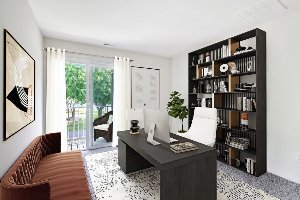 Bedroom staged as a home office with balcony access