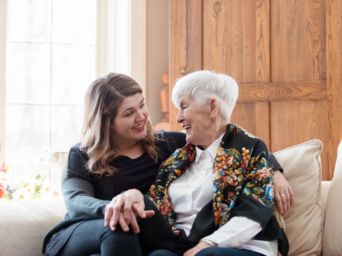 A resident and a younger family member embracing at Ativo Senior Living of Prescott Valley in Prescott Valley, Arizona.