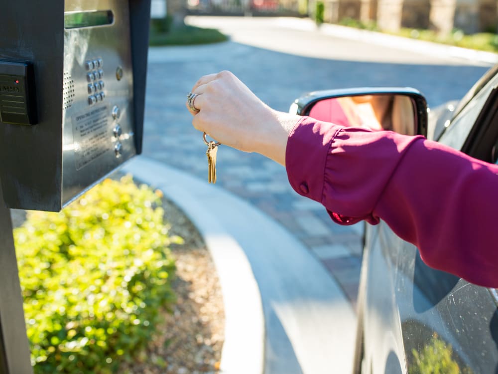 Resident opening the electronic front gate at San Marbeya in Tempe, Arizona