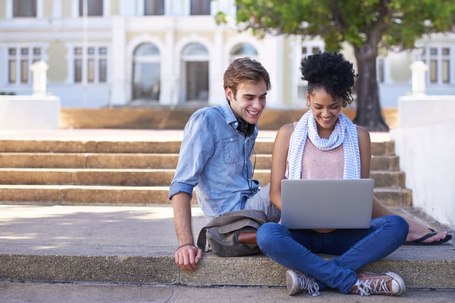 Two students looking at computer near West Towne in Ames, Iowa