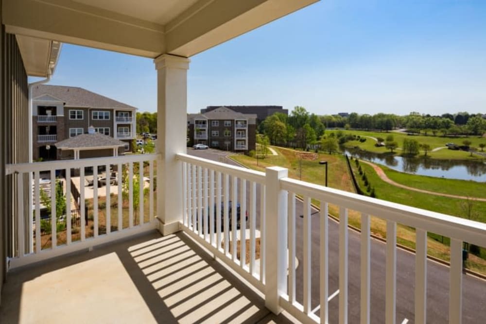 Private balcony with beautiful views of a lake and greenspace at Haywood Reserve Apartment Homes in Greenville, South Carolina