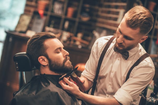 Resident of Grant Park Village getting a haircut at neighborhood barber