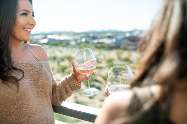 Residents enjoying drinks on their private balcony at San Privada in Gilbert, Arizona