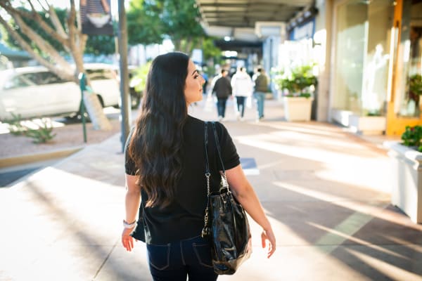 Resident walking downtown near San Hacienda in Chandler, Arizona