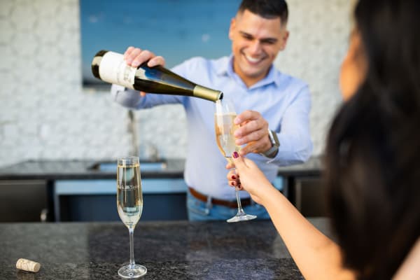 Resident enjoying wine near Lakeside Drive Apartments in Tempe, Arizona