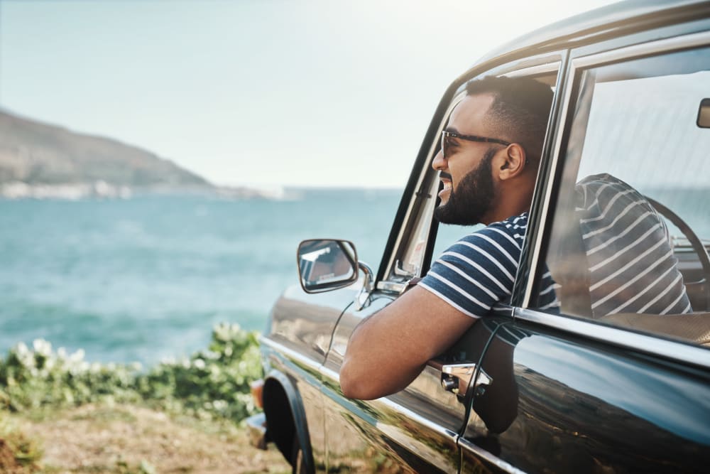 A man hanging out of his car by the coast near Castro Valley Hayward Storage LLC in Castro Valley, California