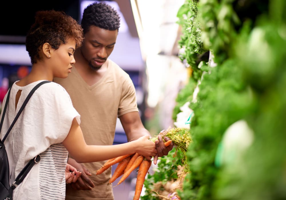 Couple shopping for produce in Garland, Texas near 5th Street Crossing at City Station