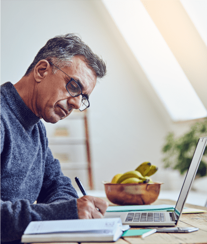 Middle-aged man working on paperwork at his desk in Luxor Club in Jacksonville, Florida