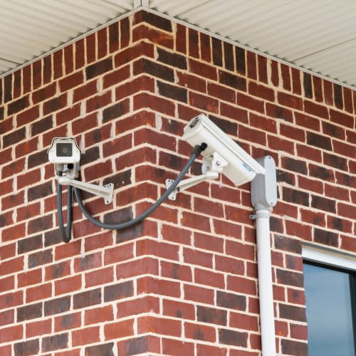 Security cameras mounted on a brick wall at Red Dot Storage in Richton Park, Illinois