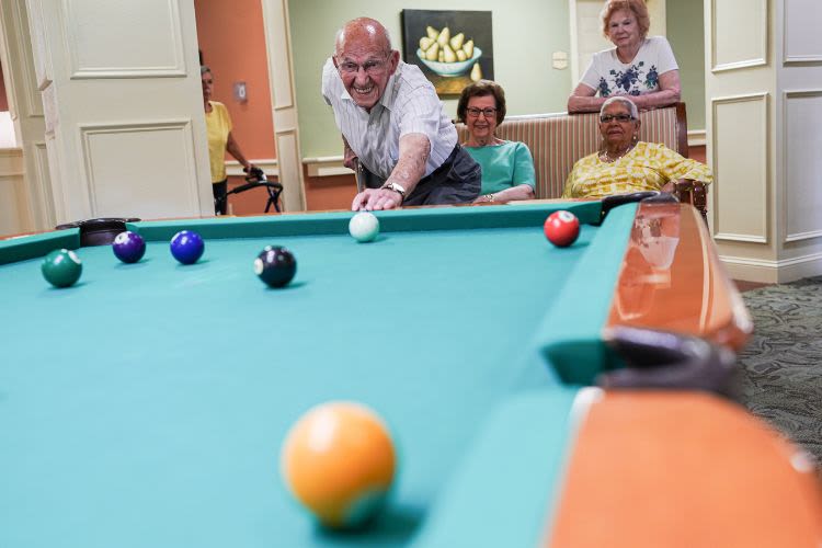 Residents playing pool at The Harmony Collection at Columbia in Columbia, South Carolina