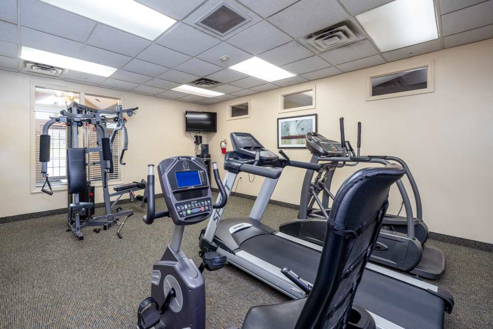Fitness center with treadmill at Greece Commons Apartments in Rochester, New York