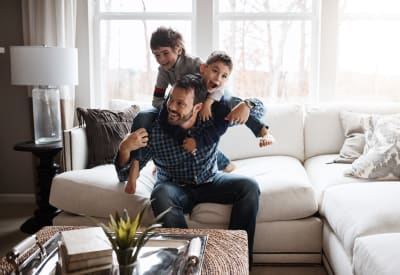 Resident dad playing with his sons at Arvada Green Apartment Homes in Arvada, Colorado