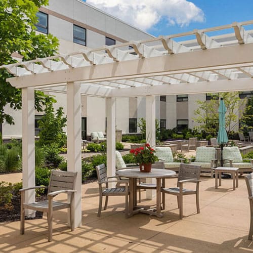Outdoor patio seating with pergola at First & Main of Commerce Township in $Commerce Township, Michigan