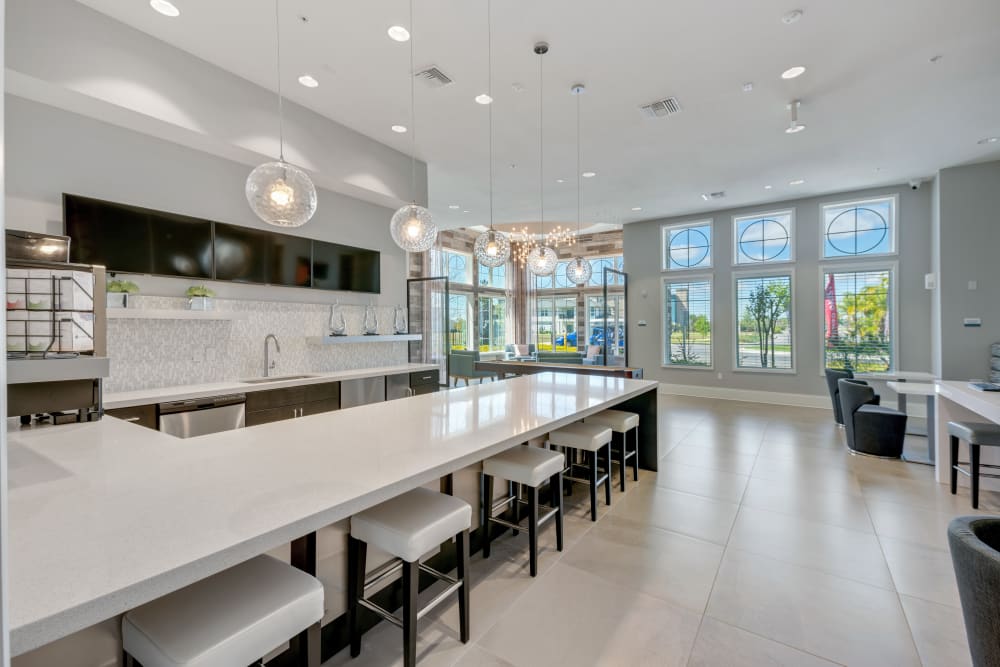 Modern and bright clubhouse kitchen at Champions Vue Apartments in Davenport, Florida