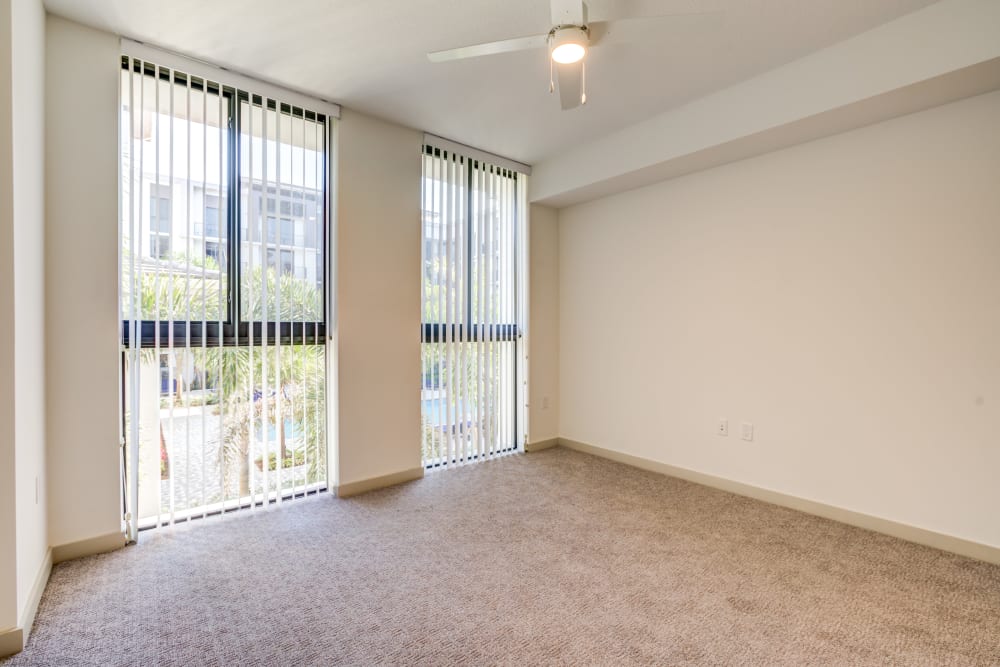 Floor to ceiling windows in a vacant bedroom at Solera at City Centre in Palm Beach Gardens, Florida