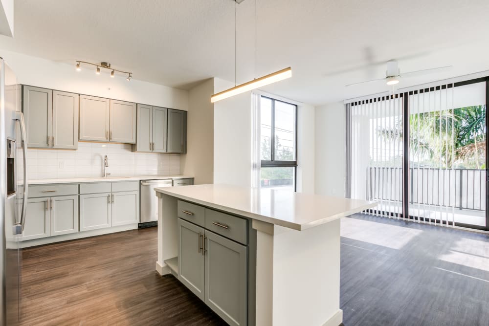 Kitchen and living room views of a vacant apartment home at Solera at City Centre in Palm Beach Gardens, Florida
