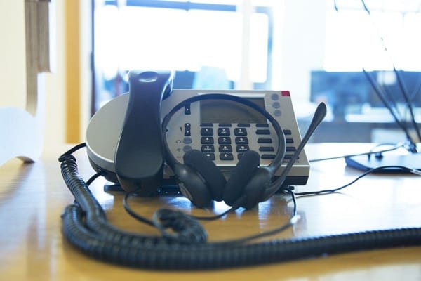 Office phone and headset on desk