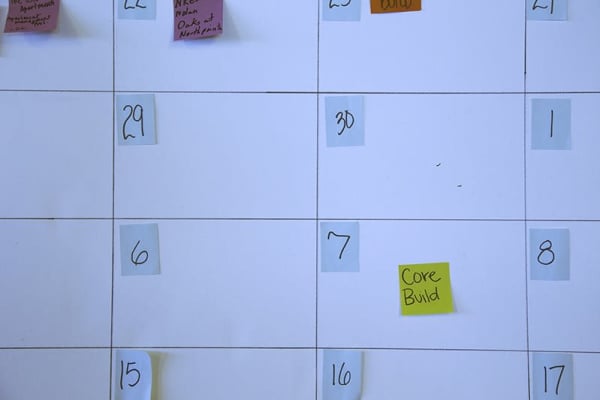 Close up of cropped calendar with a yellow sticky note that reads